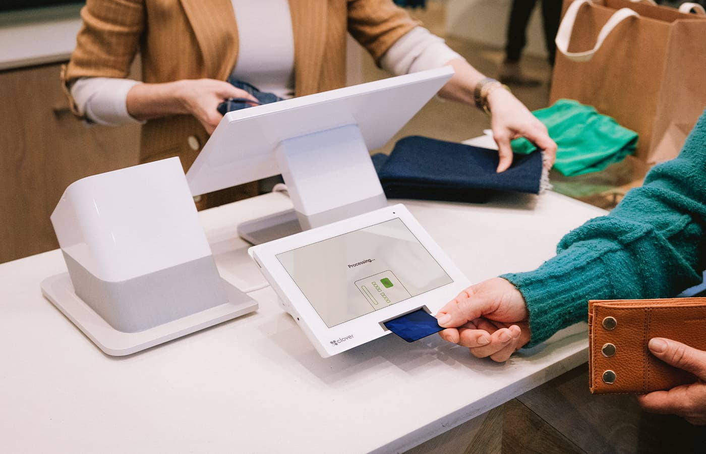 Customer paying with a Clover Station Duo at a clothing boutique